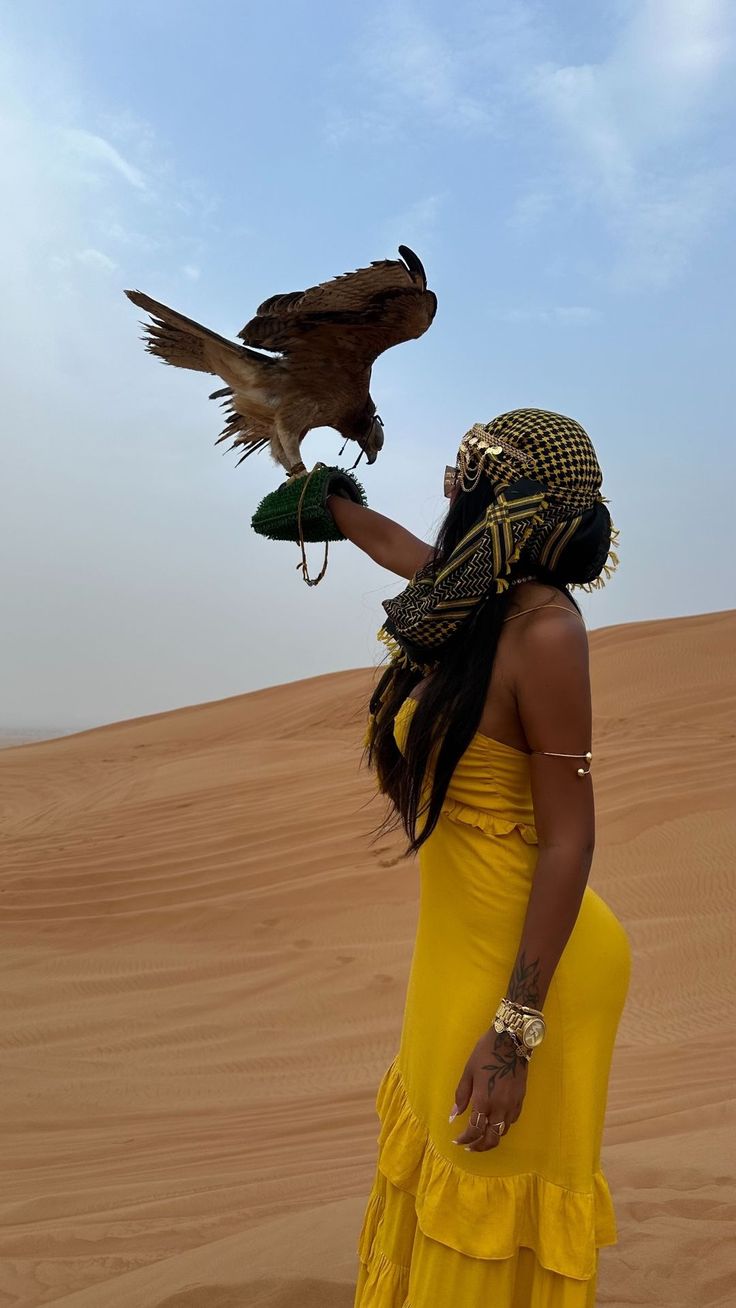 JetLife traveler holding a falcon in the Dubai desert
